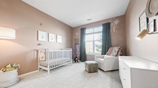 bedroom featuring lofted ceiling, a nursery area, and carpet