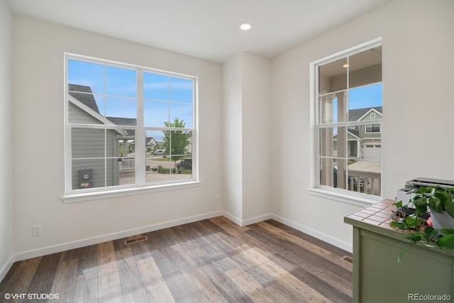 1143 Williams Loop, Elizabeth, CO 80107 - empty room featuring wood finished floors, plenty of natural light, and recessed lighting