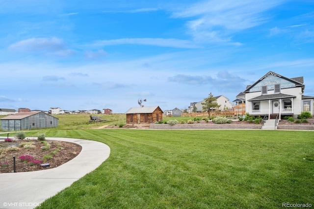 1143 Williams Loop, Elizabeth, CO 80107 - view of grassy yard featuring a residential view, an outdoor structure, and a porch