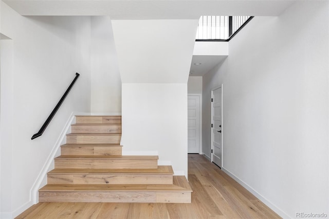 stairway with hardwood / wood-style flooring