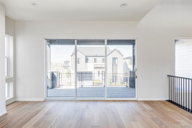 spare room with light hardwood / wood-style floors