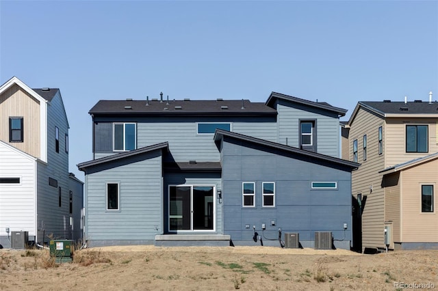 rear view of property featuring central AC