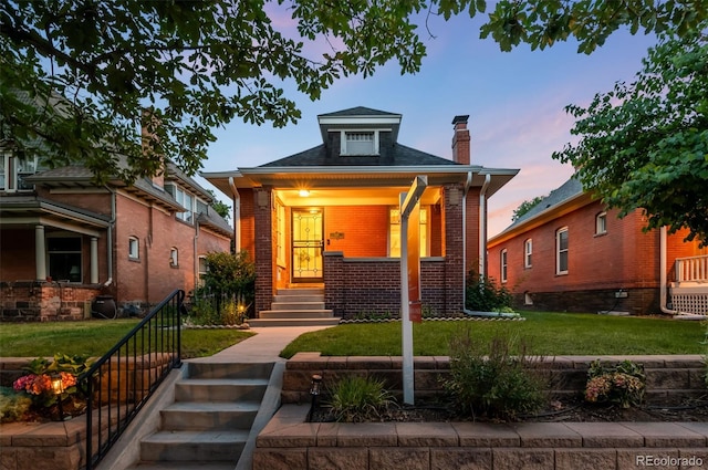 534 S Pearl St, Denver, CO 80209 - view of front facade featuring a chimney, brick siding, a yard, and stairway