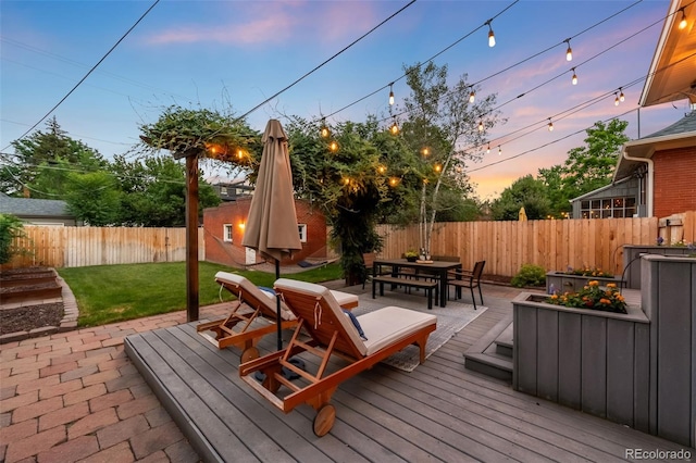 534 S Pearl St, Denver, CO 80209 - deck at dusk featuring outdoor dining space and a fenced backyard