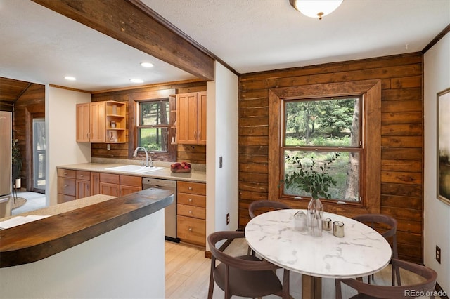 153 Divide View Dr, Golden, CO 80403 - kitchen with stainless steel dishwasher, healthy amount of natural light, light wood-style floors, rustic walls, and open shelves