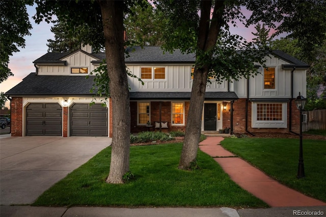 2684 Taft Ct, Lakewood, CO 80215 - view of front of home featuring board and batten siding, driveway, and brick siding