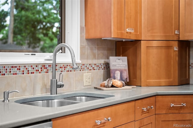 2684 Taft Ct, Lakewood, CO 80215 - kitchen featuring a sink, tasteful backsplash, light countertops, and brown cabinets
