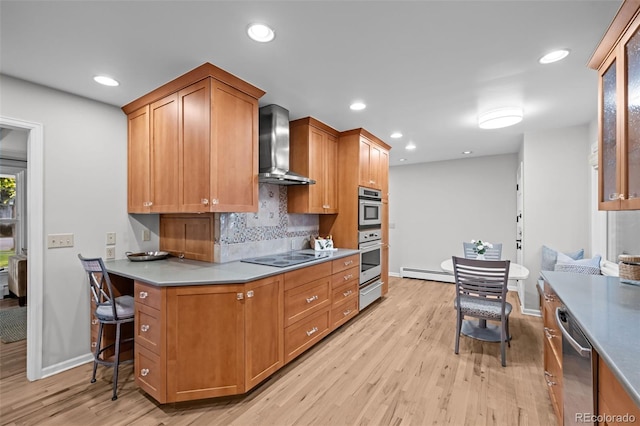 2684 Taft Ct, Lakewood, CO 80215 - kitchen featuring wall chimney range hood, appliances with stainless steel finishes, a baseboard radiator, light wood-style floors, and baseboards