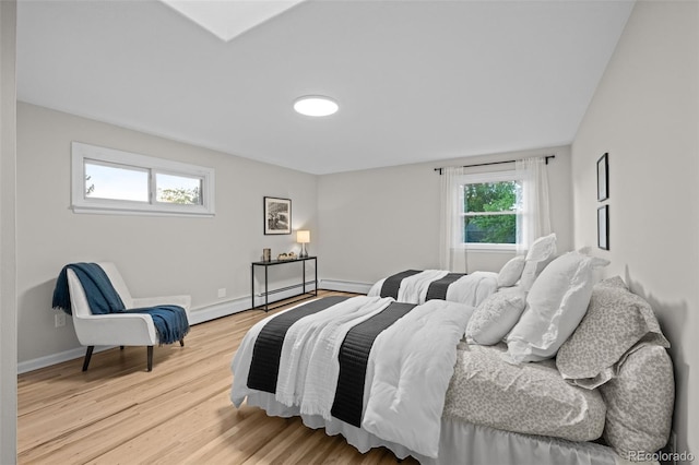 2684 Taft Ct, Lakewood, CO 80215 - bedroom featuring light wood-style floors, baseboards, and baseboard heating