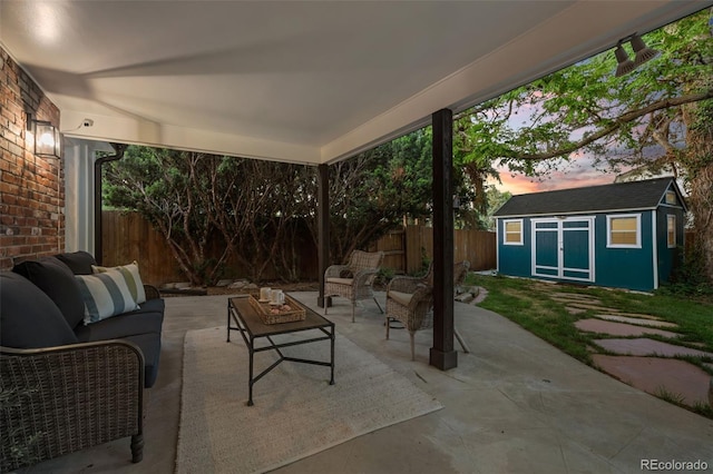 2684 Taft Ct, Lakewood, CO 80215 - patio terrace at dusk with outdoor lounge area, a patio, and a fenced backyard