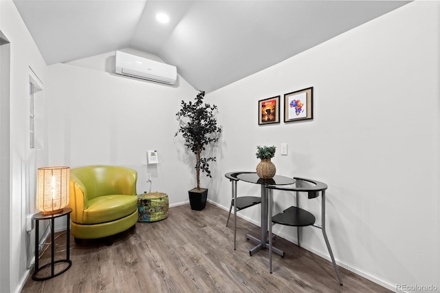 2684 Taft Ct, Lakewood, CO 80215 - living area featuring a wall mounted AC, vaulted ceiling, wood finished floors, and baseboards