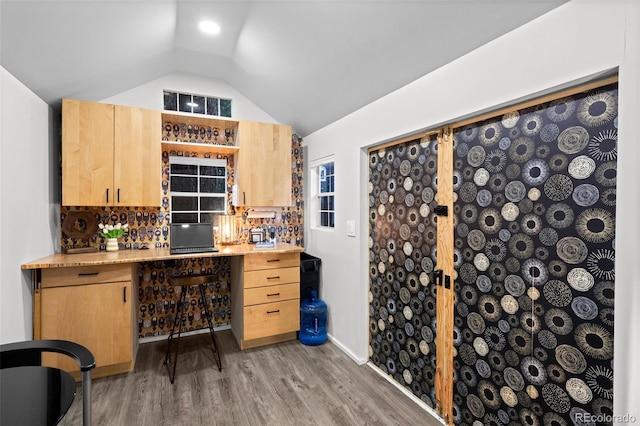 2684 Taft Ct, Lakewood, CO 80215 - wine area with lofted ceiling, light wood-style floors, and built in desk