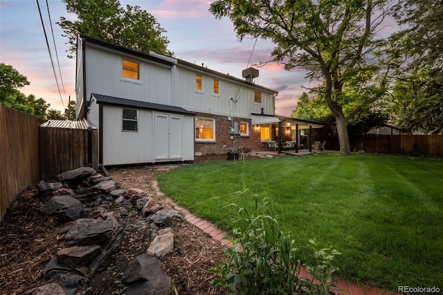 2684 Taft Ct, Lakewood, CO 80215 - back of house featuring a patio and brick siding