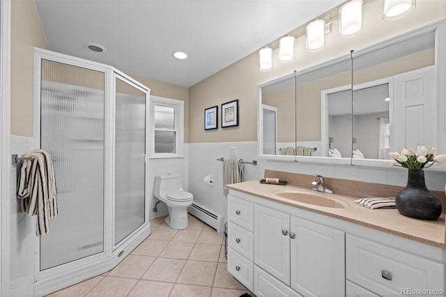 2684 Taft Ct, Lakewood, CO 80215 - bathroom with a baseboard heating unit, tile walls, vanity, a stall shower, and tile patterned floors
