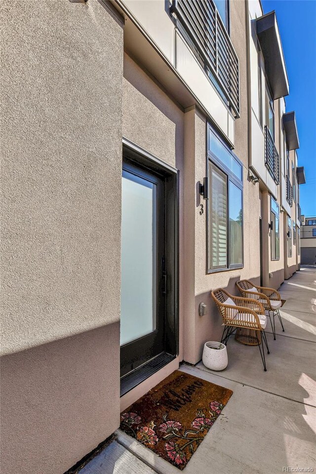 doorway to property with a patio area