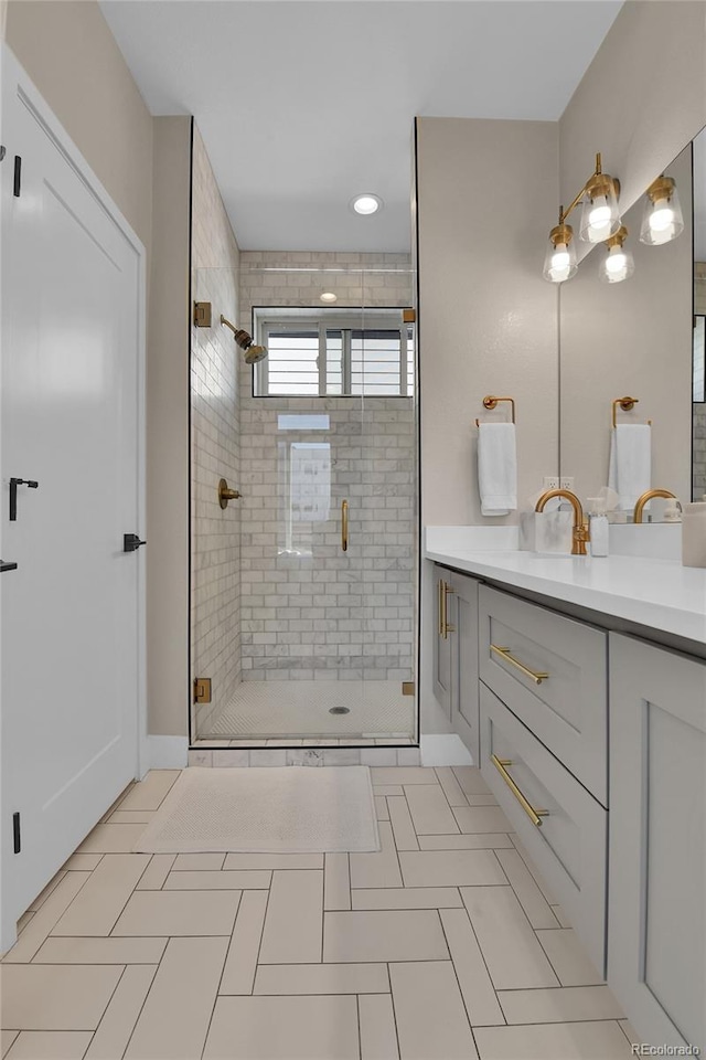 bathroom featuring an enclosed shower, vanity, and tile patterned flooring