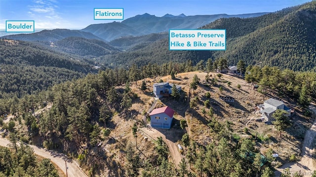 319 Camino Bosque, Boulder, CO 80302 - aerial view of property and surrounding area with a forest and mountains