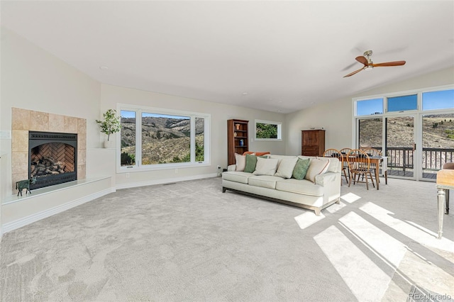 319 Camino Bosque, Boulder, CO 80302 - carpeted living room featuring a ceiling fan, a tiled fireplace, and vaulted ceiling