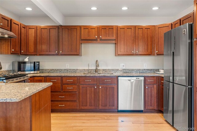 319 Camino Bosque, Boulder, CO 80302 - kitchen featuring appliances with stainless steel finishes, light stone countertops, light wood finished floors, ventilation hood, and recessed lighting
