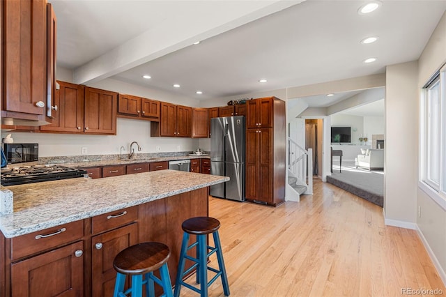 319 Camino Bosque, Boulder, CO 80302 - kitchen with stainless steel appliances, a peninsula, a breakfast bar, light wood-style floors, and recessed lighting