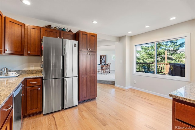 319 Camino Bosque, Boulder, CO 80302 - kitchen with stainless steel appliances, light wood-type flooring, recessed lighting, and light stone counters