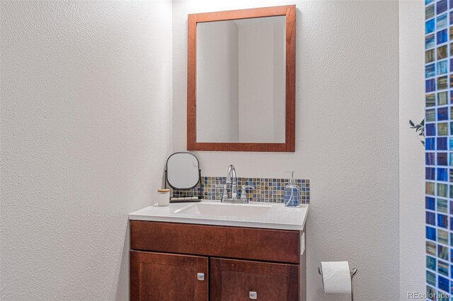 319 Camino Bosque, Boulder, CO 80302 - bathroom with vanity, tasteful backsplash, and a textured wall