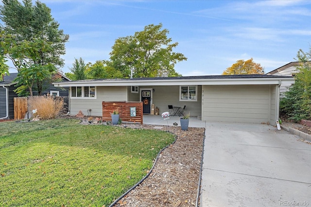 ranch-style home with concrete driveway and a front yard