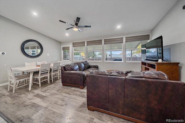 living area with recessed lighting, lofted ceiling, light wood-style floors, and a ceiling fan