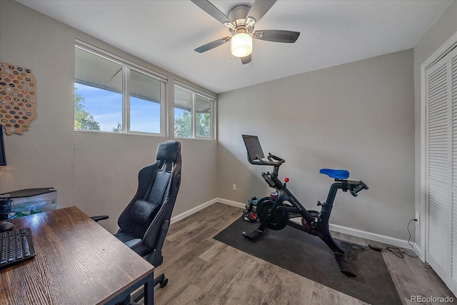 office space featuring wood finished floors, baseboards, and ceiling fan