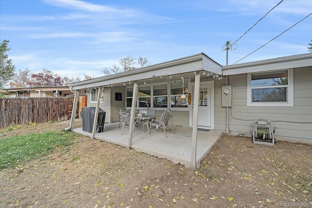 back of property with a patio and fence