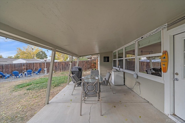 view of patio with outdoor dining space and a fenced backyard