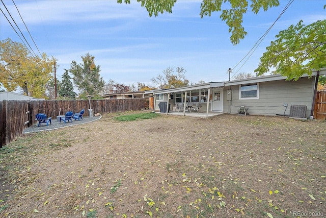 rear view of property featuring central AC, a fenced backyard, and a patio area