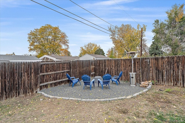 view of yard featuring a fenced backyard and an outdoor fire pit