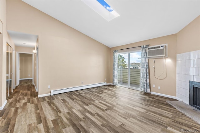 unfurnished living room with a tile fireplace, hardwood / wood-style floors, a wall mounted air conditioner, a skylight, and baseboard heating