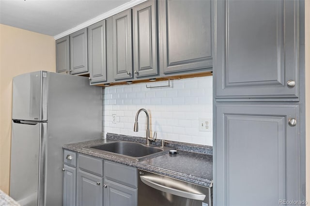 kitchen with gray cabinetry, sink, tasteful backsplash, and stainless steel appliances