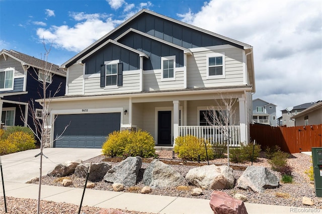 view of front of house featuring covered porch, fence, an attached garage, concrete driveway, and board and batten siding