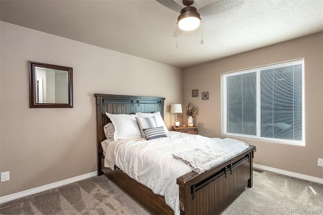 carpeted bedroom featuring baseboards and a ceiling fan