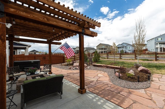 view of patio / terrace featuring a hot tub, a pergola, a fenced backyard, and a residential view