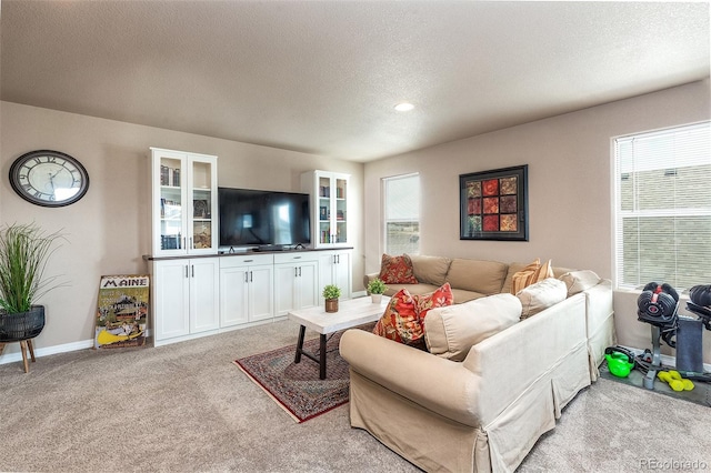 living room featuring light carpet, a textured ceiling, baseboards, and recessed lighting