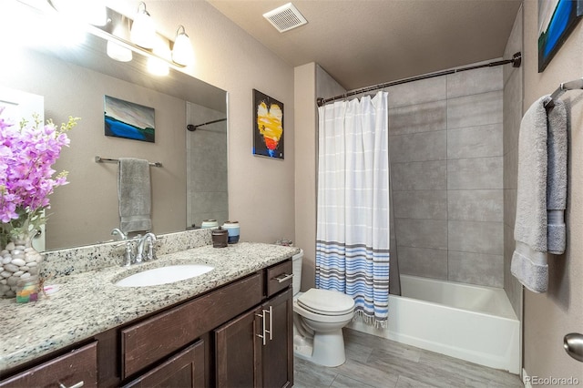 full bathroom with shower / bath combination with curtain, toilet, wood finished floors, visible vents, and vanity