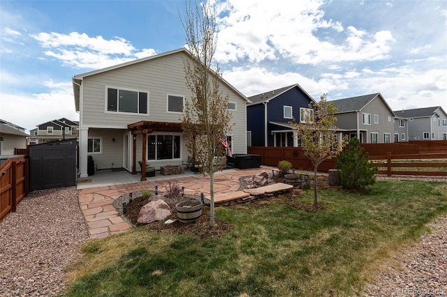 back of property with a yard, a patio, and a fenced backyard