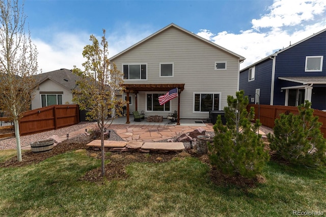 back of property featuring a patio, a lawn, and a fenced backyard