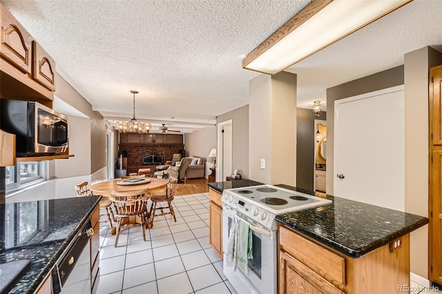 3150 Lane Ct, Boulder, CO 80305 - kitchen with white appliances, open floor plan, a textured ceiling, light tile patterned flooring, and a brick fireplace