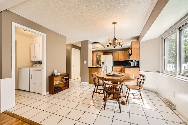 3150 Lane Ct, Boulder, CO 80305 - dining area featuring washing machine and clothes dryer, a chandelier, a textured ceiling, and light tile patterned floors