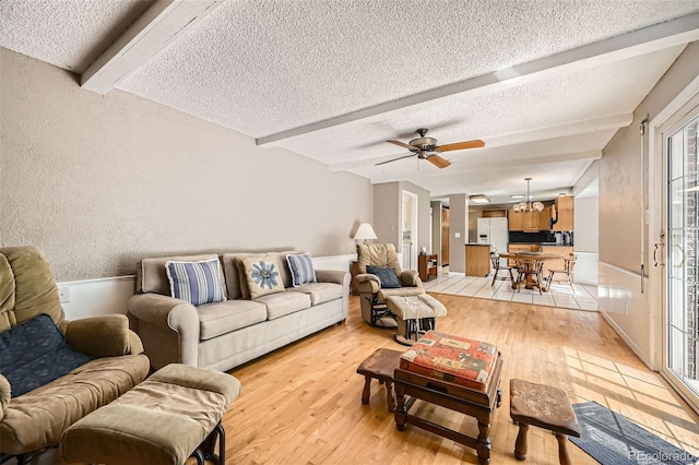 3150 Lane Ct, Boulder, CO 80305 - living area with a textured ceiling, beamed ceiling, light wood finished floors, a chandelier, and ceiling fan