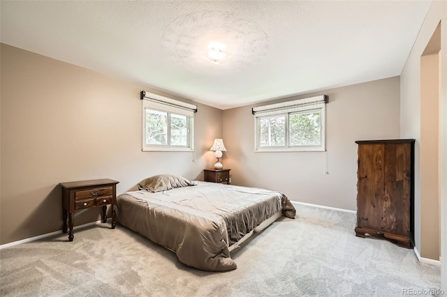 3150 Lane Ct, Boulder, CO 80305 - carpeted bedroom featuring a textured ceiling, multiple windows, and baseboards