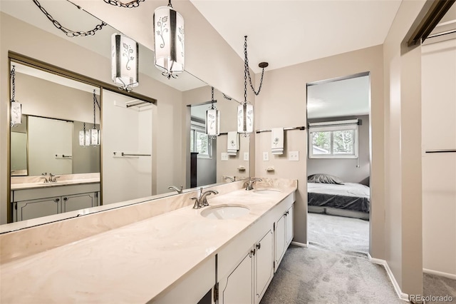 3150 Lane Ct, Boulder, CO 80305 - full bath with double vanity, connected bathroom, and baseboards