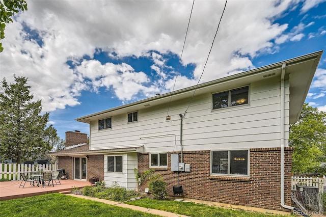 3150 Lane Ct, Boulder, CO 80305 - rear view of house with brick siding and a patio