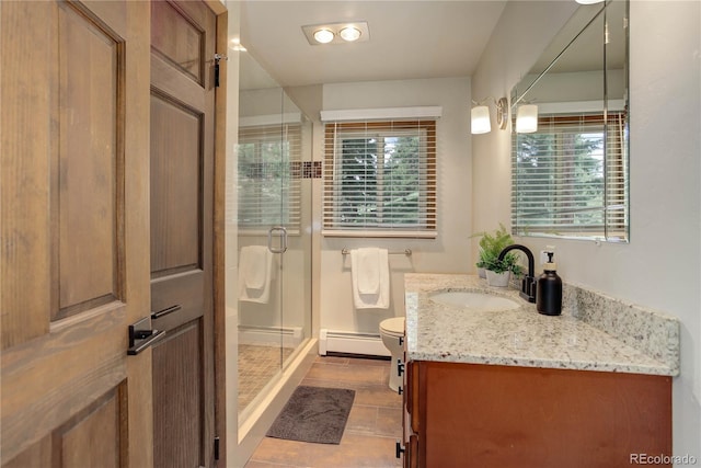 30221 Marge Ln, Evergreen, CO 80439 - full bathroom with baseboard heating, vanity, a stall shower, and tile patterned flooring