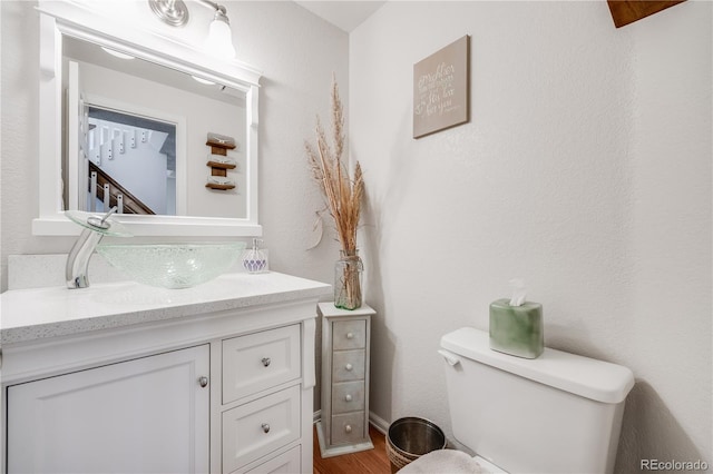 11760 Eudora Ct, Thornton, CO 80233 - half bathroom featuring vanity, toilet, and wood finished floors